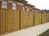 Timber fence with brick house